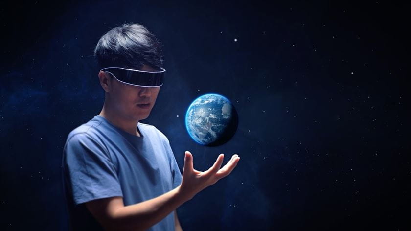 Man with virtual realtiy glasses holding the earth