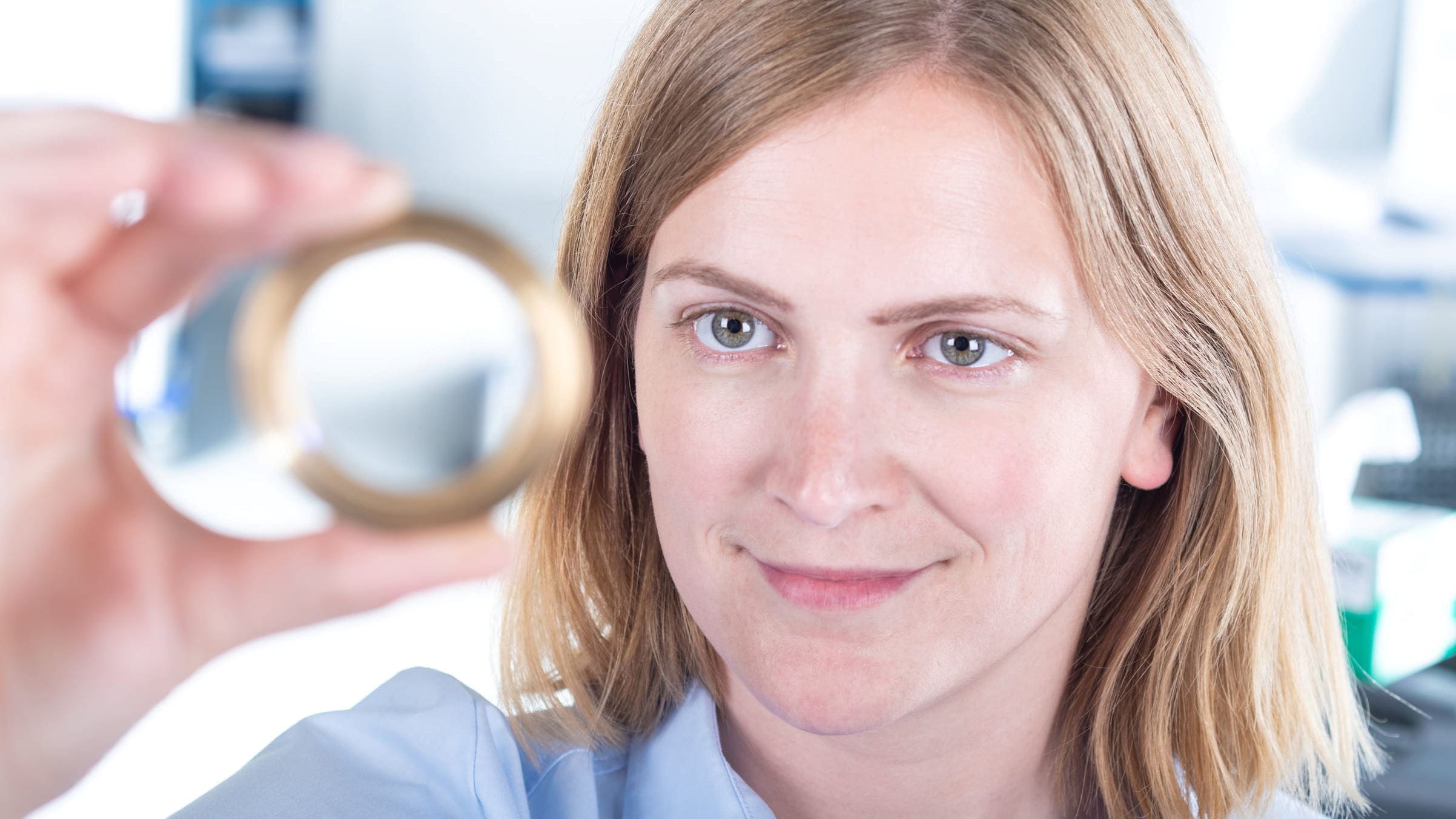 Woman holding a lens up high